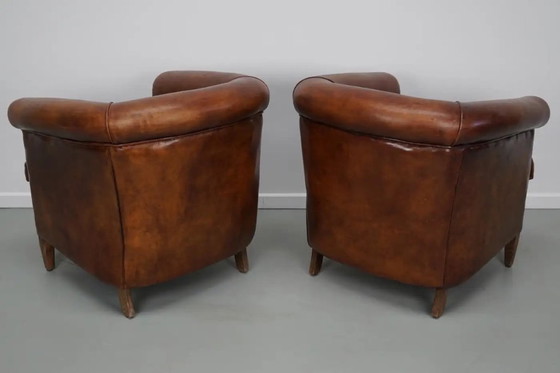 Image 1 of Vintage Nederlandse leren clubfauteuils in cognackleur, set van 2 met voetenbank