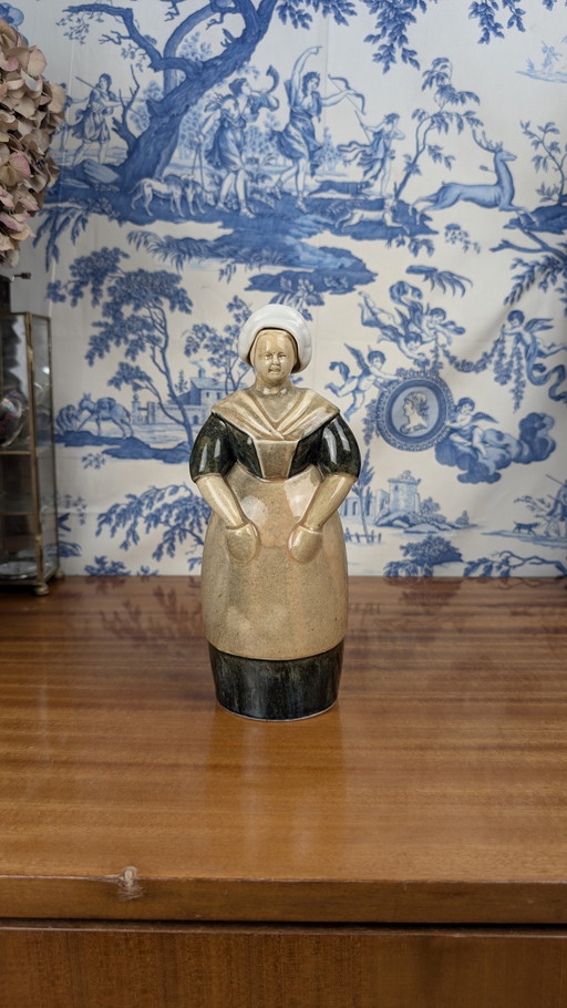 Denbac pour Noyer Berrichonne shepherdess anthropomorphic liqueur bottle, early 20th century ceramics