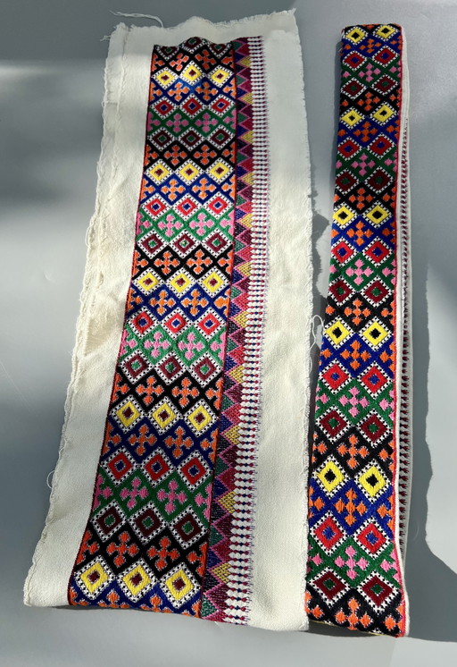 Two Hungarian borders with colorful hand embroidery with a folkloristic pattern