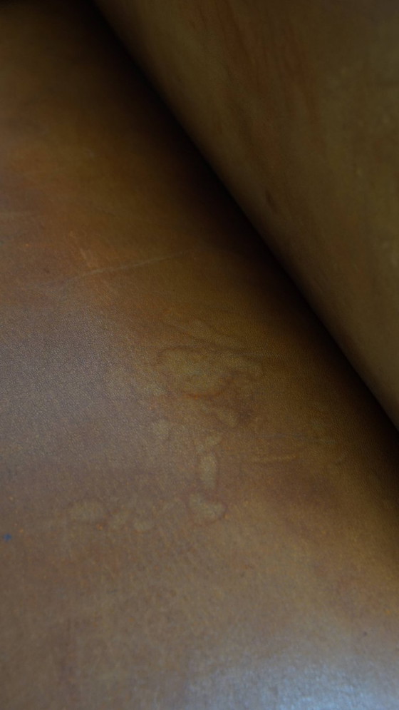 Image 1 of Schapenleren armchair met een afwerking met donkerbruine biezen