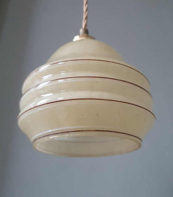 Image 1 of Vintage hanglamp - amberkleurig glas met spots en goudkleurige biezen.