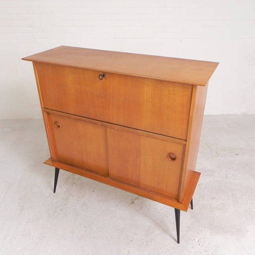 Secretaire with sliding doors on slender legs, 1950s