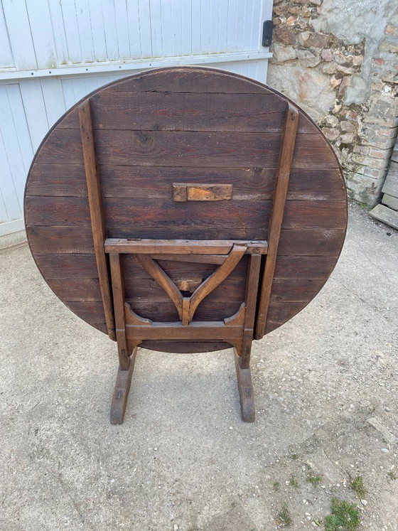 Image 1 of antique folding round winemaker's target table with tilting top