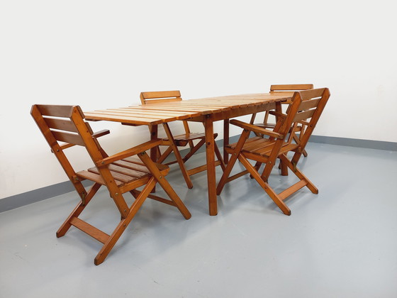 Image 1 of Vintage garden furniture consisting of a table with extensions and 4 wooden armchairs from the 60s