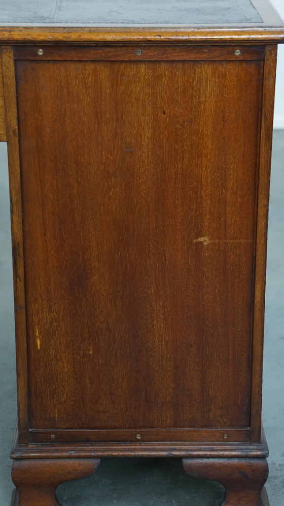 Image 1 of Luxurious and antique English wooden desk from the late 19th century with a leather top and a curved front.