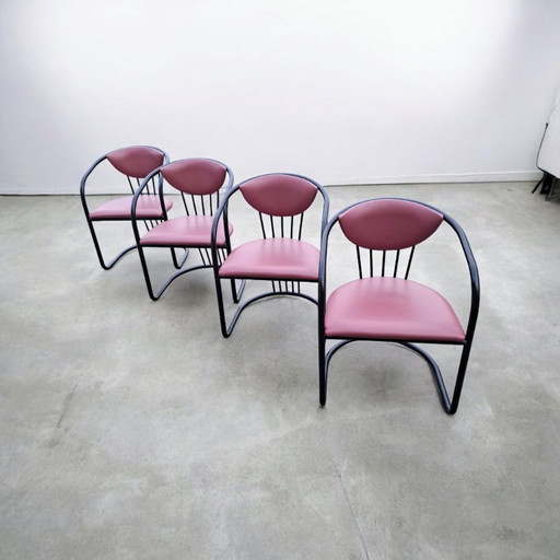 This is a set of four vintage 'Memphis' style chairs with a black metal frame and burgundy upholstery.