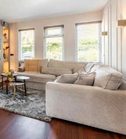 Grote hoekbank van ribstof in lichte kleur