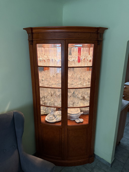 Corner display cabinet made of cherry wood with lighting