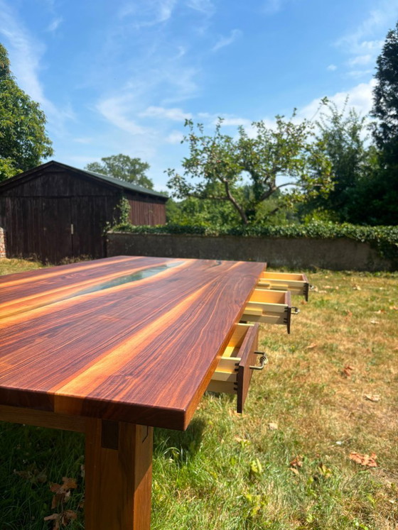 Image 1 of Dining table in American walnut and maple. Handcrafted solid wood extensions and drawers. Live edge for visual depth. Epoxy resi