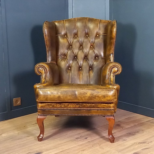 Cognac colored Vintage chesterfield armchair. 1 of 2