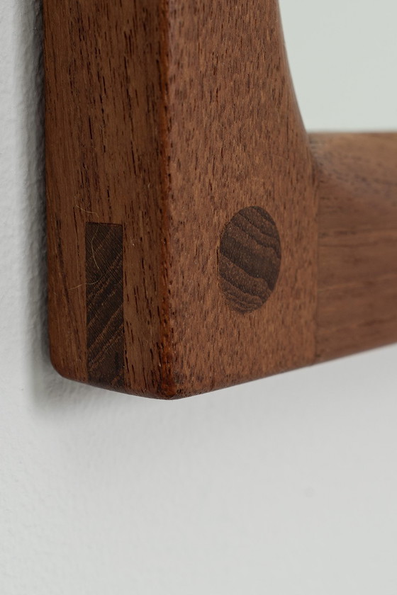 Image 1 of Aksel Kjersgaard in front of Odder Møbler mirror