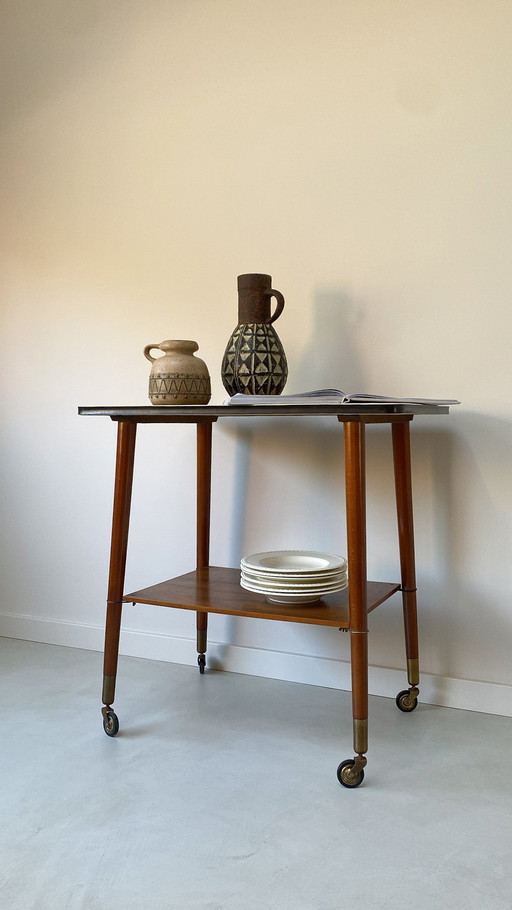 Vintage wooden trolley on wheels with formica top