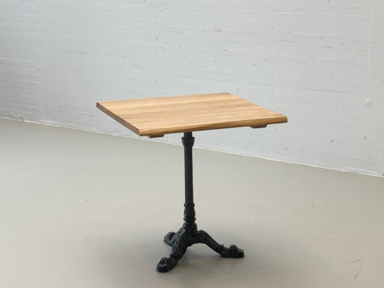 Image 1 of Bistro table made of acacia wood with a cast iron base in country style