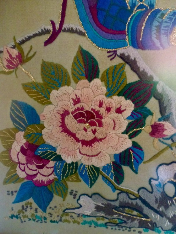 Image 1 of Vintage hand-embroidered wall tapestry, behind glass, with a crane, butterflies and flowers.