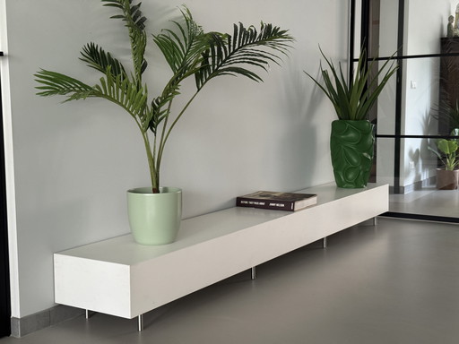 Two white plant tables with steel adjustable legs