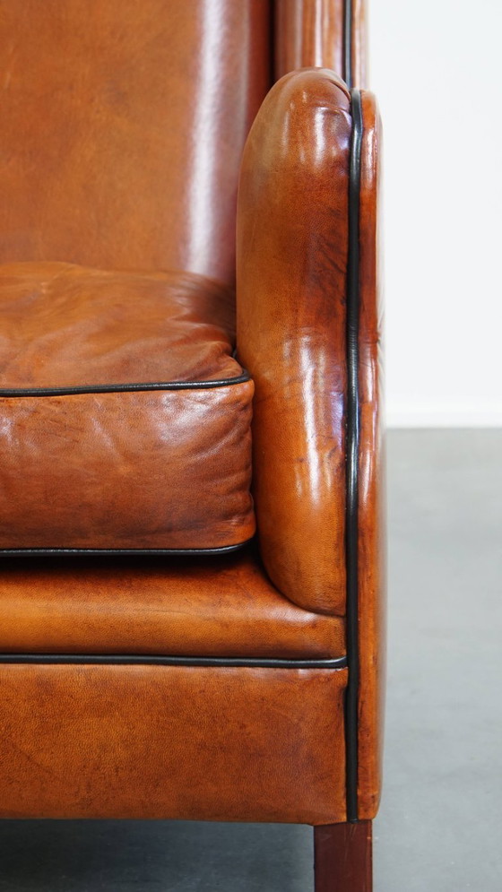 Image 1 of Schapenleren armchair met hoge rug en zwarte biezen 