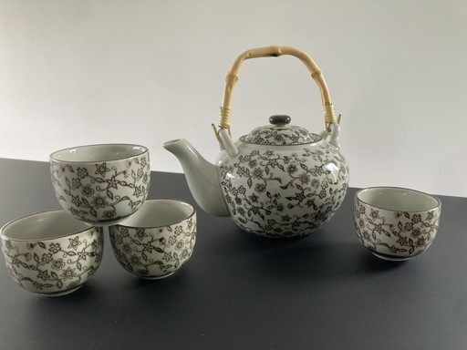 Gray ceramic tea set with brown floral pattern, four cups and a teapot