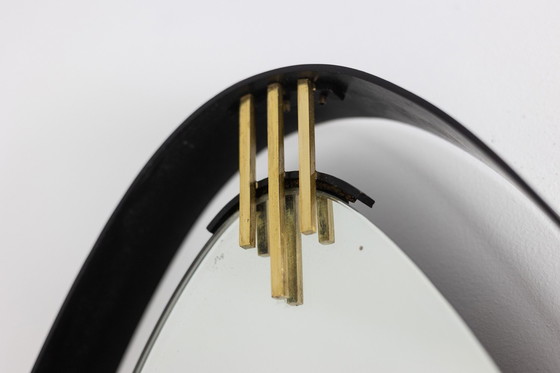 Image 1 of Lacquered and patinated brass mirror, ovoid shape. Circa 1950/60.