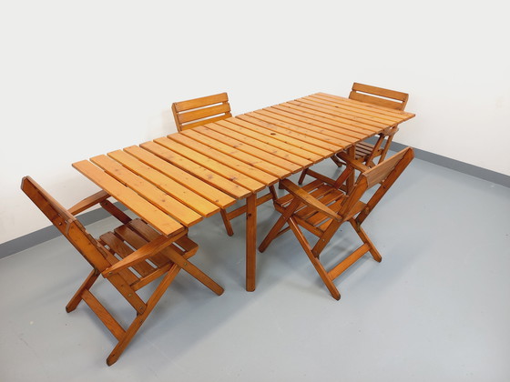 Image 1 of Vintage garden furniture consisting of a table with extensions and 4 wooden armchairs from the 60s