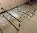 Minimalist glass design coffee table with geometric metal frame – €140