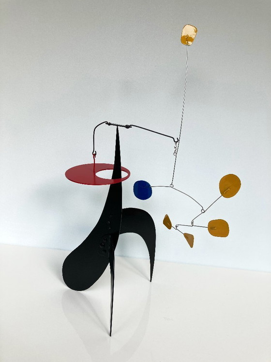 Image 1 of 5 Yellow And 1 Blue on a black stabile