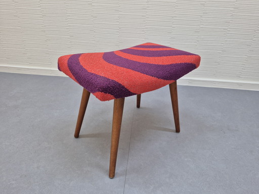Vintage footstool with graphic print in orange/purple.