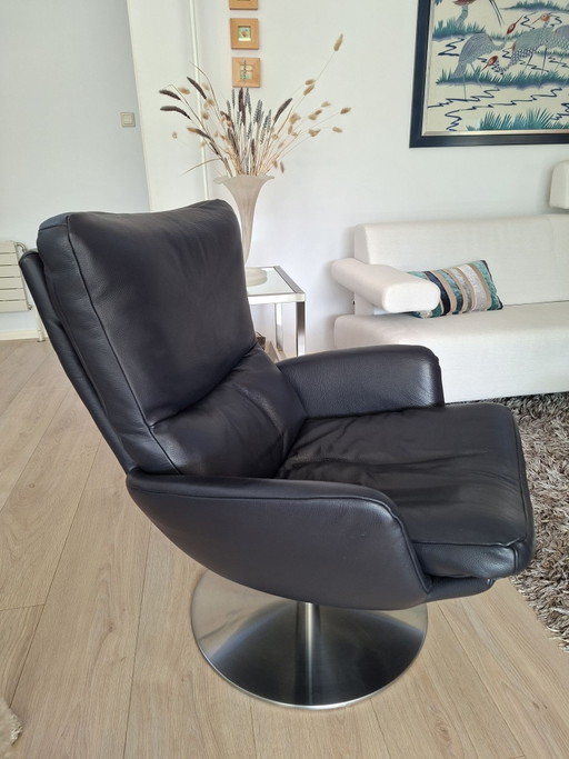 Blue swivel armchair with brushed chrome base