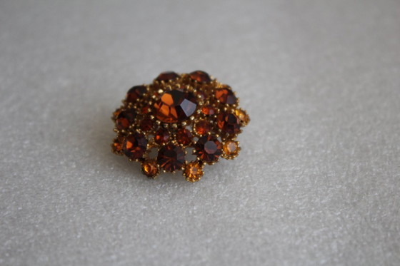 Image 1 of Vintage costume jewelry brooch with amber rhinestones, marked SPHINX