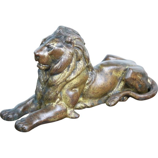Vintage lying lion in gold cast iron