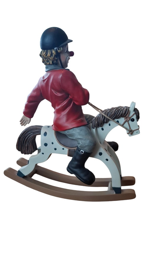 Guild clown on rocking horse