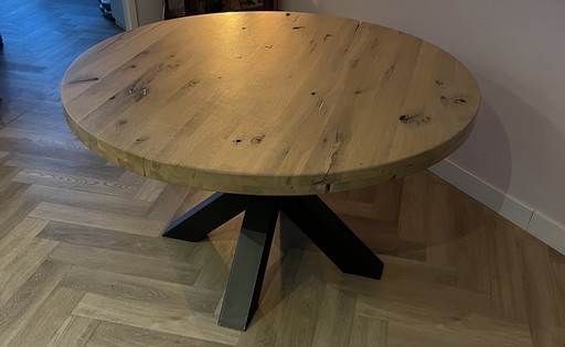 Round oak wooden dining table with industrial steel legs