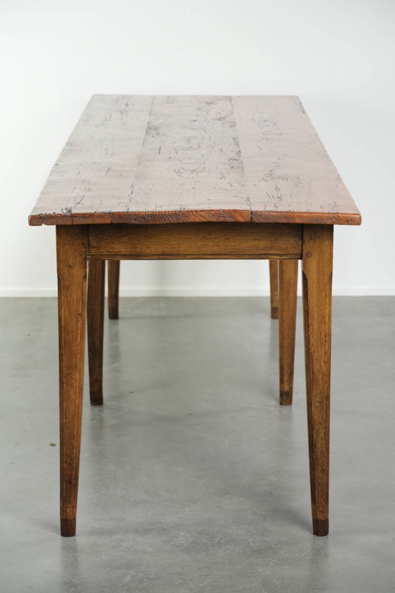 Image 1 of Large, relatively narrow antique French farmhouse dining table made of pine from the early 19th century with a beautiful patina.