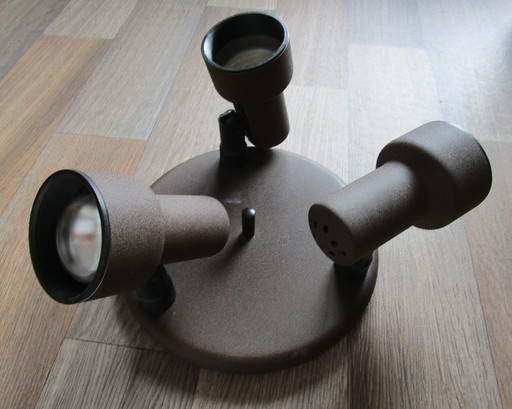 Vintage brown metal ceiling lamp with three adjustable spotlights.