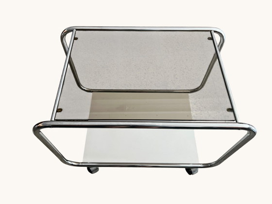 Image 1 of Vintage Space Age side table made of chrome and smoked glass. Sculptural 70s design with wheels.