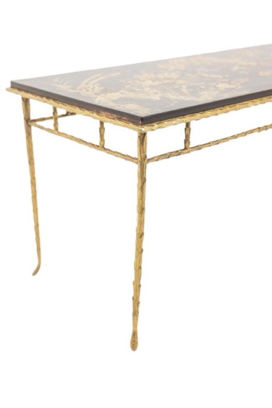 Image 1 of Maison Baguès. Mesa de centro en bronce, laca negra y detalles dorados. Hacia 1970.