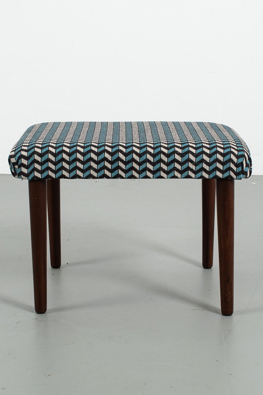 Footstool reupholstered with graphic pattern