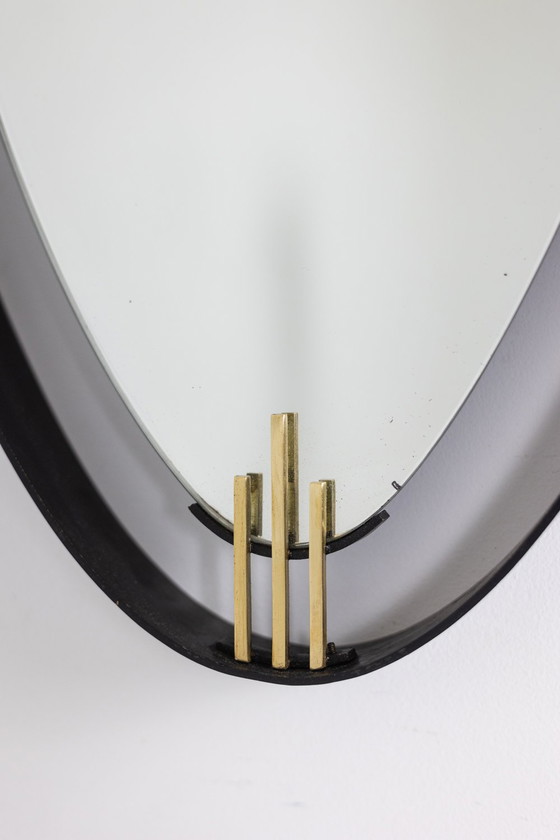 Image 1 of Lacquered and patinated brass mirror, ovoid shape. Circa 1950/60.