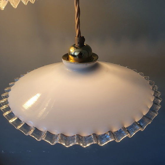 Image 1 of 2 vintage hanglampen van wit opaline glas met een transparante sierrand.
