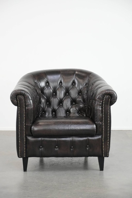 Luxurious dark cowhide Chesterfield club armchair in English style