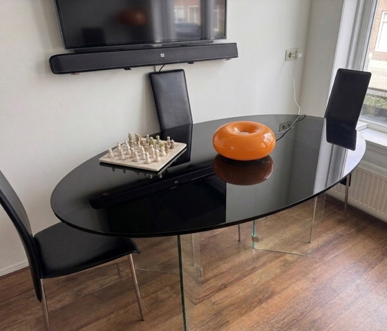 Image 1 of Oval smoked glass dining table