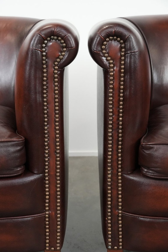 Image 1 of 2 poltrone club in pelle bovina in buone condizioni, di un lussuoso colore rosso/marrone.