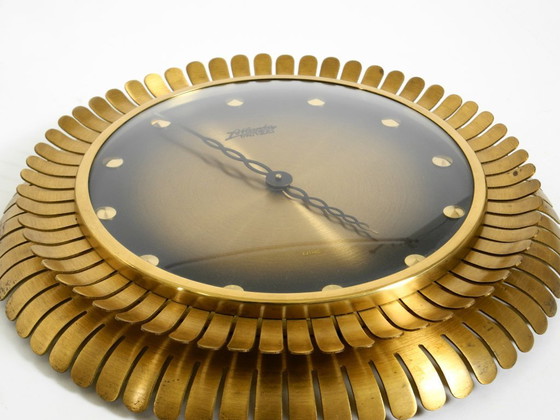 Image 1 of Beautiful original Mid Century Sunburst Atlanta Universe wall clock made of heavy brass with a mechanical seven-day movement