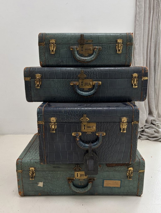 Set of four vintage suitcases with crocodile print