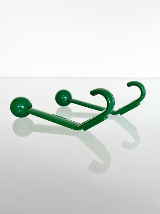 Set of two vintage green-colored plastic wall hooks