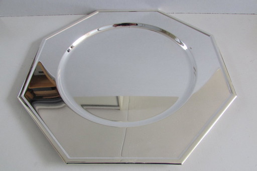 Dos platos base plateados en su embalaje original.