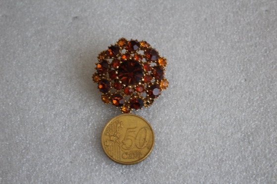 Image 1 of Vintage costume jewelry brooch with amber rhinestones, marked SPHINX