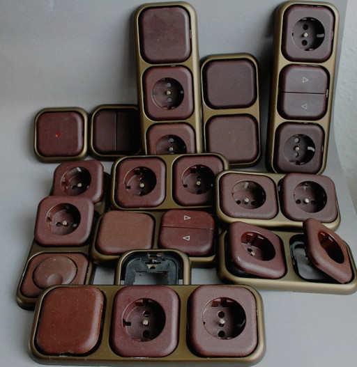 Large collection of vintage brown sockets and light switches with antique gold frames, 1960s/70s