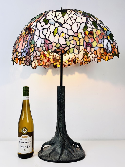 Lámpara de mesa Tiffany extragrande con base de tronco de árbol y pantalla floral.