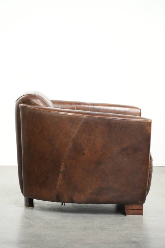 Image 1 of Karaktervolle en stoere donker cognac bruine rundleren Aviator design fauteuil/ armchair met een interessante vorm