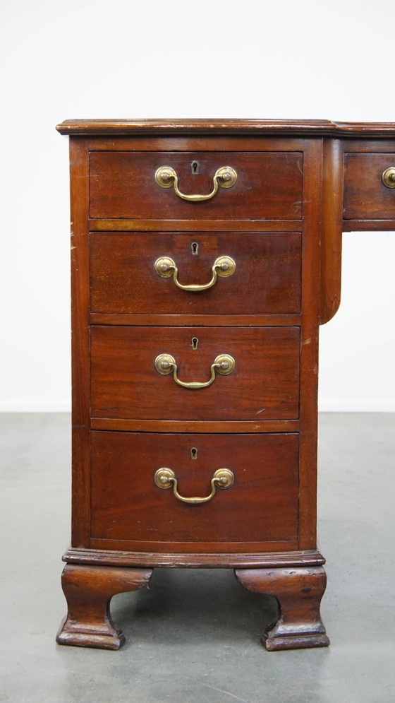 Image 1 of Luxurious and antique English wooden desk from the late 19th century with a leather top and a curved front.